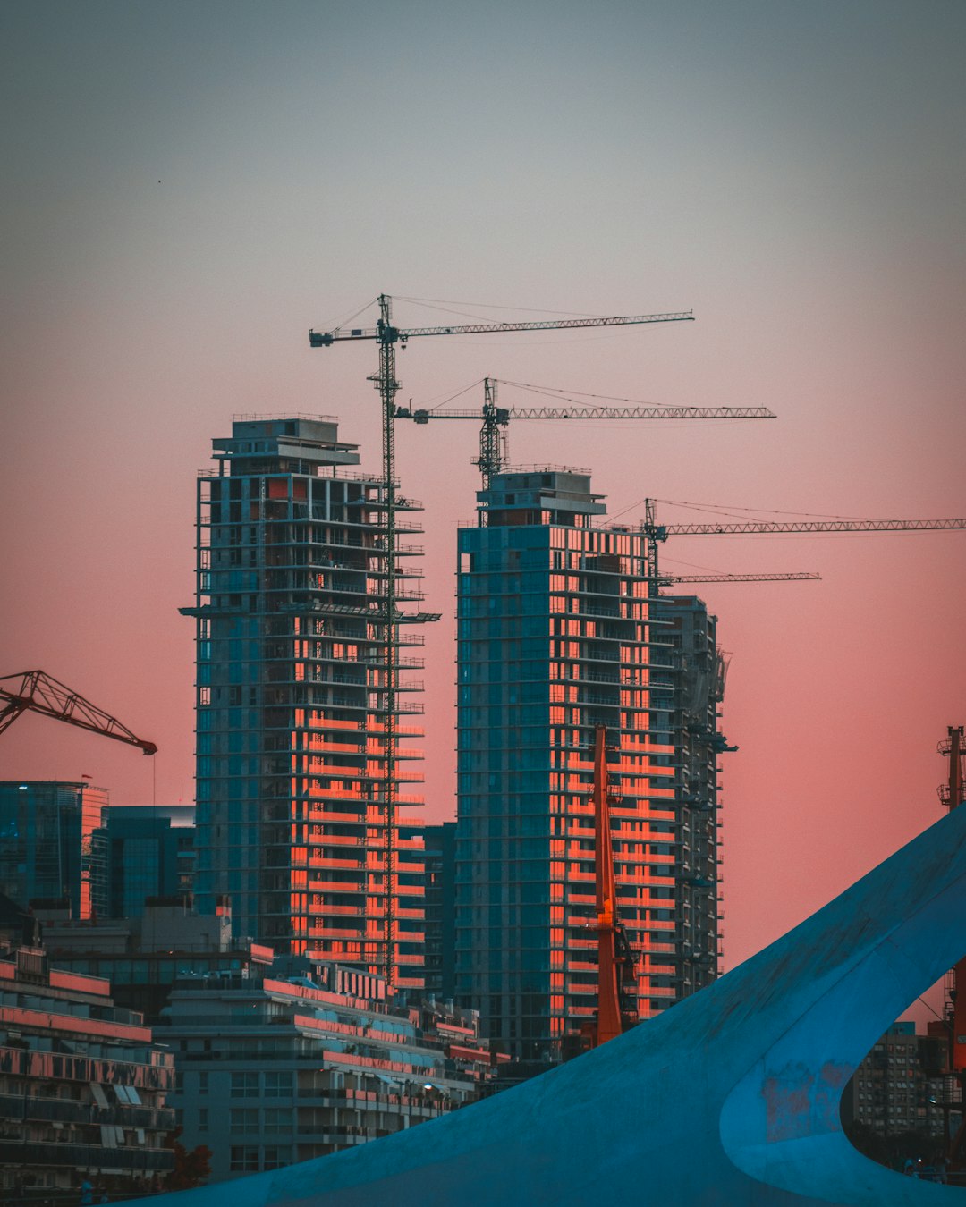 about-02 gray-building-crane-photo-during-sunset-2ykxqikhnfk